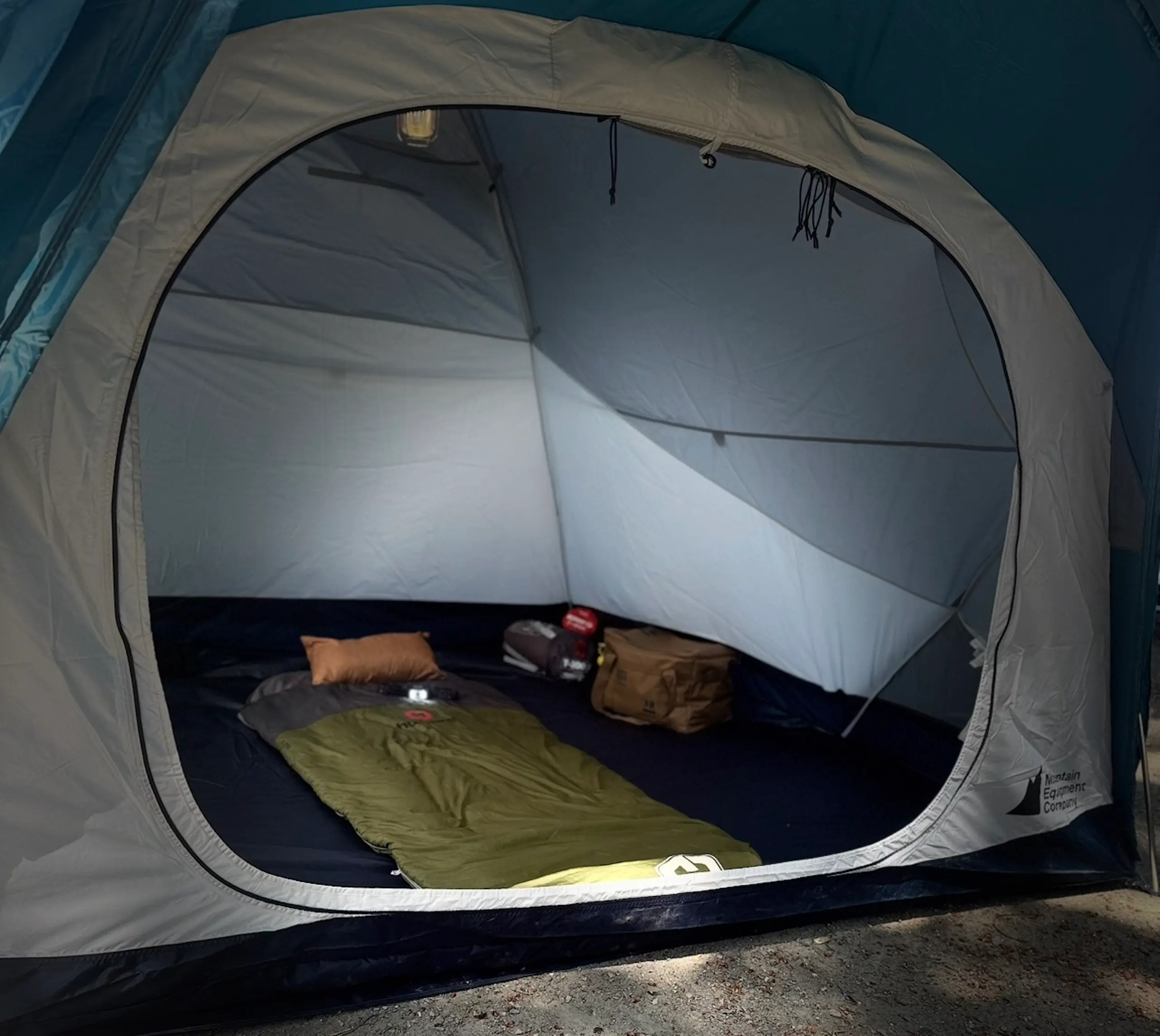 Inside the MEC tent with sleeping bags and pads